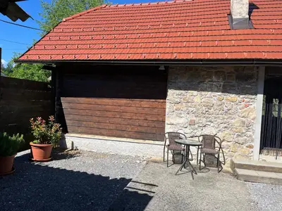 a patio with a table and chairs in front of a building at Hisa Suzana in Črnomelj