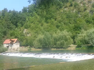 a house on the side of a river at Hisa Suzana in Črnomelj