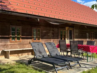 a group of chairs sitting in front of a house at Hisa Suzana in Črnomelj
