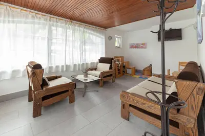 a living room with wooden furniture and a couch at Apartments Bor in Bohinj