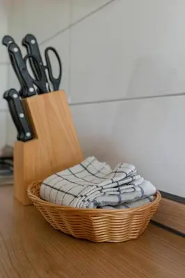 a basket with a bunch of pairs of scissors at Apartments Bor in Bohinj