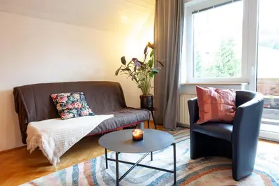 a living room with a couch and a table at Apartments Kosir in Kranjska Gora