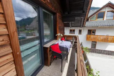 a table on the balcony of a house at Apartments Kosir in Kranjska Gora