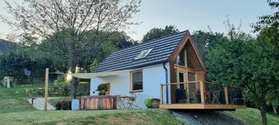 a small house with a gambrel roof at Hiška pod črešnjo in Rogašovci