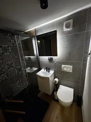 a small bathroom with a toilet and a sink at Hiška pod črešnjo in Rogašovci