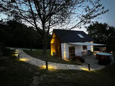 a small house with lights in front of it at Hiška pod črešnjo in Rogašovci