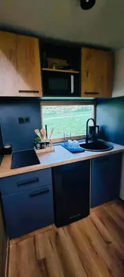 a small kitchen with a sink and a window at Hiška pod črešnjo in Rogašovci
