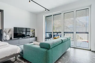 a living room with a couch and a large window at Adventure Oasis Bovec in Bovec