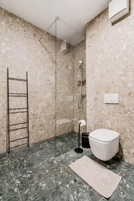 a bathroom with a toilet and a glass shower at Adventure Oasis Bovec in Bovec