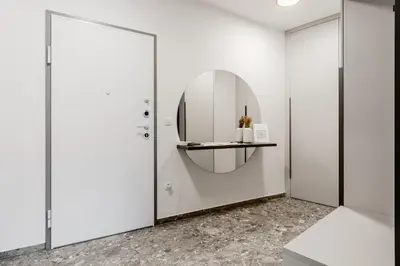 a white room with a mirror and a door at Adventure Oasis Bovec in Bovec