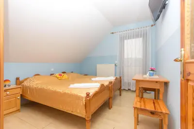 a small bedroom with a bed and a table at Guesthouse Kaučič in Benedikt v Slovenskih Goricah