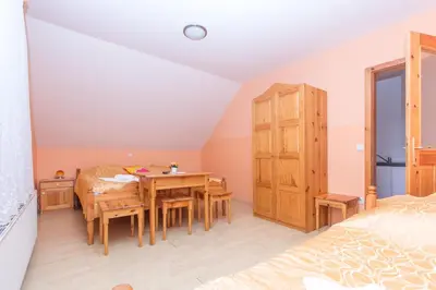a bedroom with a dining room table and a bed at Guesthouse Kaučič in Benedikt v Slovenskih Goricah