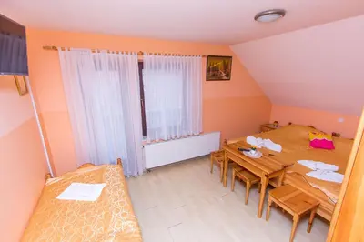 a room with a table and two chairs and a window at Guesthouse Kaučič in Benedikt v Slovenskih Goricah
