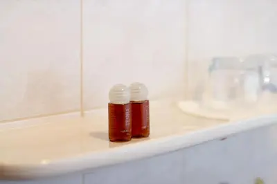two bottles of honey sitting on a shelf in a bathroom at Guesthouse Kaučič in Benedikt v Slovenskih Goricah