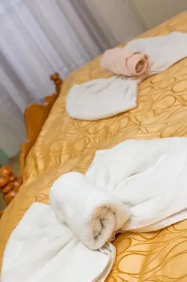 a woman laying on a bed with towels at Guesthouse Kaučič in Benedikt v Slovenskih Goricah