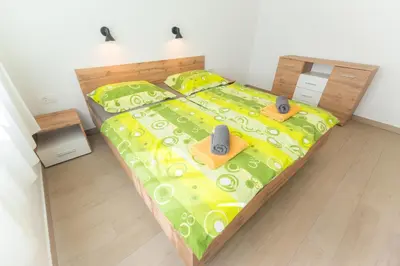 a bedroom with a bed with speakers on it at Apartma Gojsa in Bovec