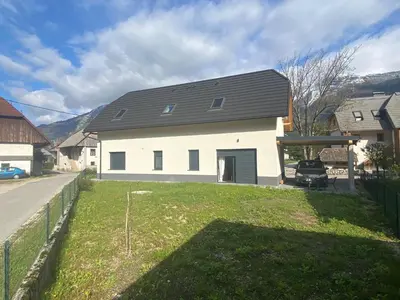 a white house with a black roof at Apartma Gojsa in Bovec
