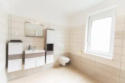 a bathroom with a toilet and a sink and a window at Apartma Gojsa in Bovec
