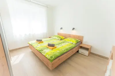 a bedroom with a bed in a white room at Apartma Gojsa in Bovec
