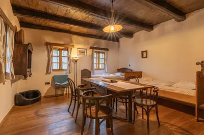 a room with a table and chairs and a bed at Goricko Natural Chalets in Križevci