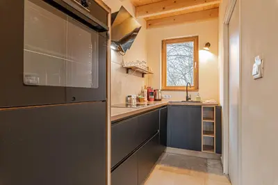 a small kitchen with a sink and a refrigerator at Goricko Natural Chalets in Križevci