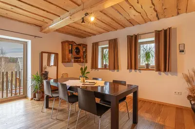 a dining room with a table and chairs at Goricko Natural Chalets in Križevci