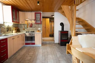 a kitchen with a staircase and a stove at Ski Hut Smučka in Kranjska Gora