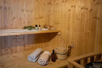 a wooden sauna with towels and a shelf in it at Ski Hut Smučka in Kranjska Gora