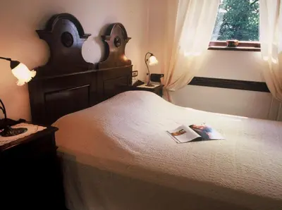 a bedroom with a bed with a book on it at Apartments Bledea in Bled