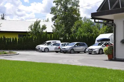 a group of cars parked in a parking lot at Apartments Bledea in Bled