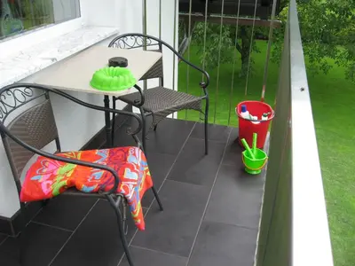 a patio with a table and chairs on a balcony at Apartments Bledea in Bled
