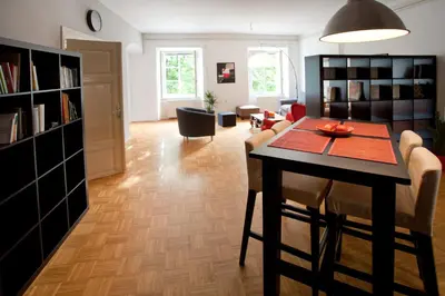 a dining room and living room with a table and chairs at Apartment REZIDENCA GOGA in Novo Mesto