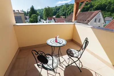 a balcony with a table and chairs on a balcony at APART HOTEL ASTERIA in Ljubljana