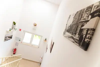 a staircase in a house with a picture on the wall at APART HOTEL ASTERIA in Ljubljana