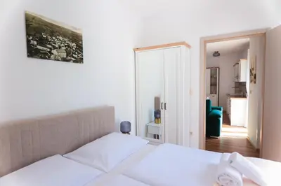 a bedroom with a bed and a living room at APART HOTEL ASTERIA in Ljubljana