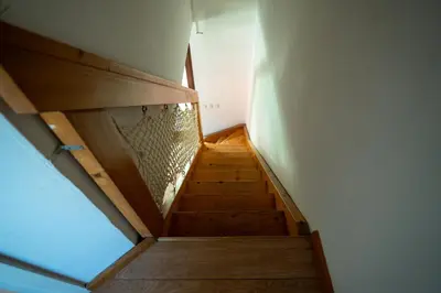 a staircase in a house with a wooden stair case at Apartment 47 Sara, Terme Čatež in Čatež ob Savi