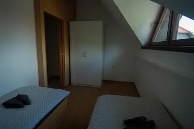 a small bedroom with a bed and a window at Apartment 47 Sara, Terme Čatež in Čatež ob Savi