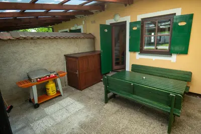 a green bench and a table on a patio at Apartment 47 Sara, Terme Čatež in Čatež ob Savi