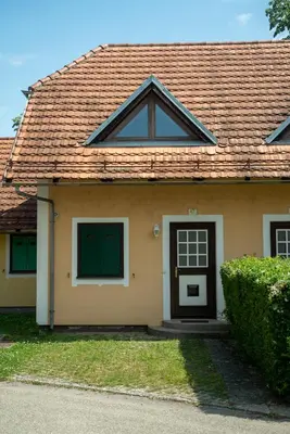 a house with a brown roof and a black door at Apartment 47 Sara, Terme Čatež in Čatež ob Savi