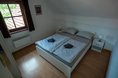 a small bedroom with a bed and a window at Apartment 47 Sara, Terme Čatež in Čatež ob Savi