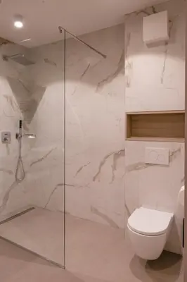a bathroom with a toilet and a glass shower at HIŠA PUTR in Trzin