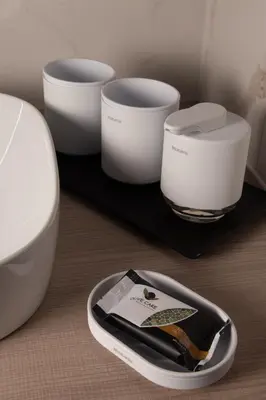 a tray with three bowls and a toilet on a table at HIŠA PUTR in Trzin