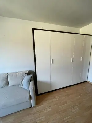 a living room with a couch and a large cabinet at Apartment in Ljubljana center in Ljubljana