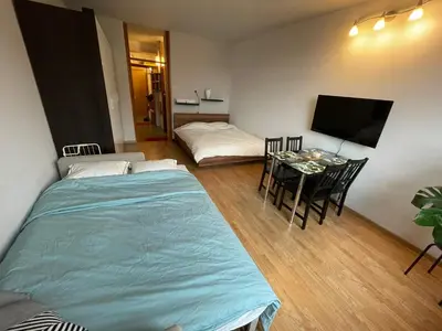 a room with a bed and a table and a television at Apartment in Ljubljana center in Ljubljana