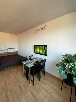 a dining room with a table and chairs and a tv at Apartment in Ljubljana center in Ljubljana