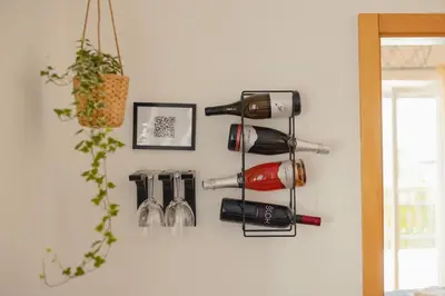 a bunch of wine bottles hanging on a wall at VILA KLARA apartments in Ljubljana