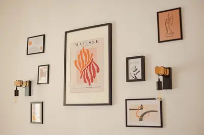 a wall with framed pictures on a wall at VILA KLARA apartments in Ljubljana