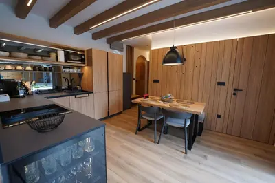 a kitchen with a table and some chairs in a room at Suita beli Labod in Medvode