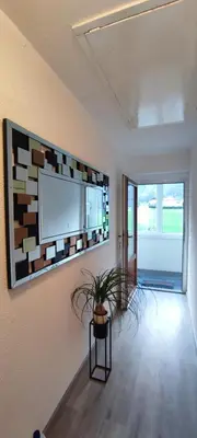 a living room with a flat screen tv on a wall at Apartma Soča Oasis in Srpenica