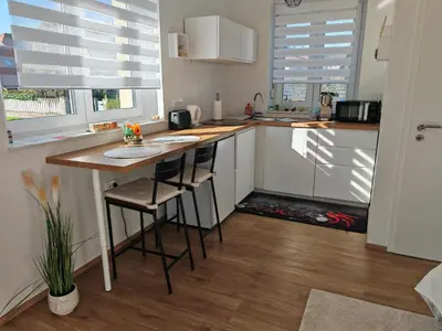 a kitchen with a counter and a table with stools at YELLOW APARTMENT WITH FREE PARKING in Ljubljana